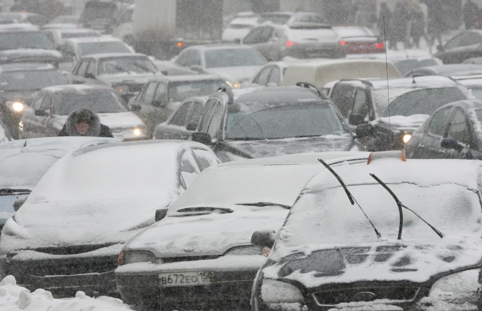 Cars are stuck in a traffic jam during heavy snowfall in central Moscow